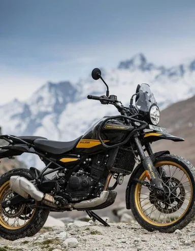 The Royal Enfield Himalayan parked on rocky ground below snowy mountains