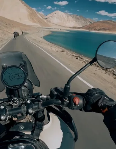 Rider's view over the handlebars along a turquoise lake
