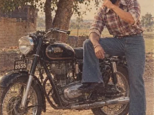 A vintage Royal Enfield Bullet with its owner, decades ago